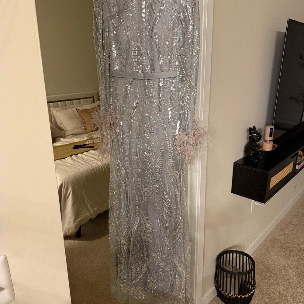 Elegant Silver Sequin Gown with Feather Details